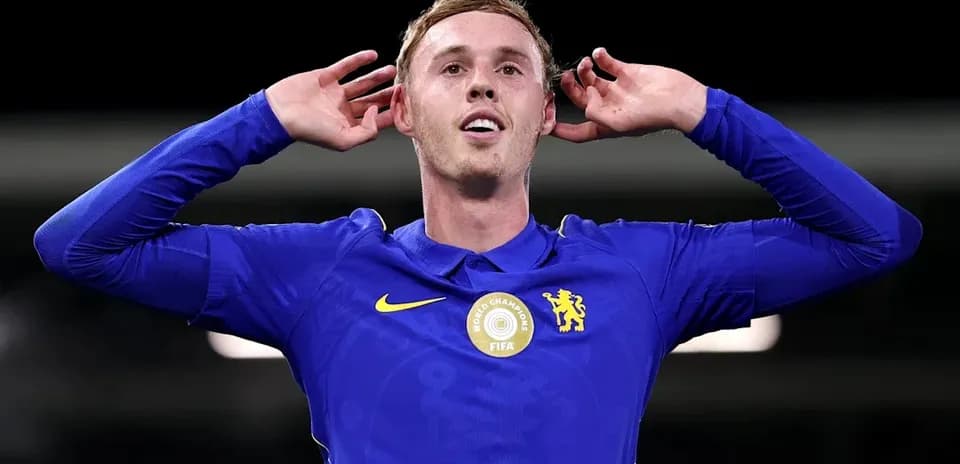 Player celebrating with hands to ears in blue kit