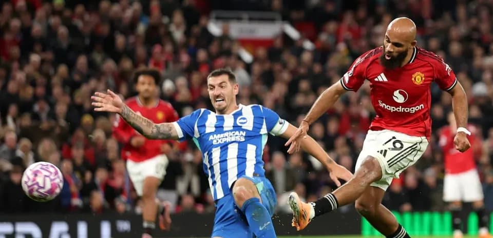 Brighton player tackling Manchester United opponent