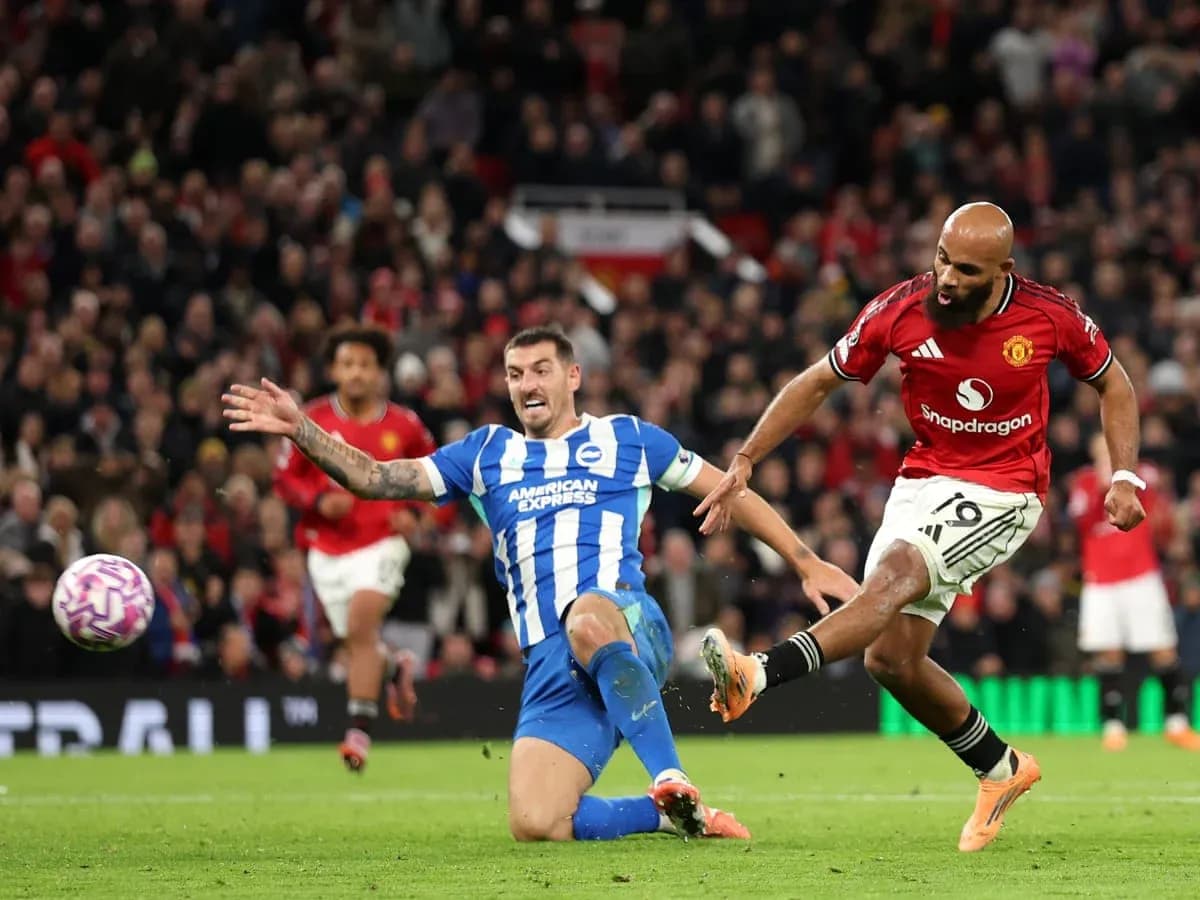 Brighton player tackling Manchester United opponent