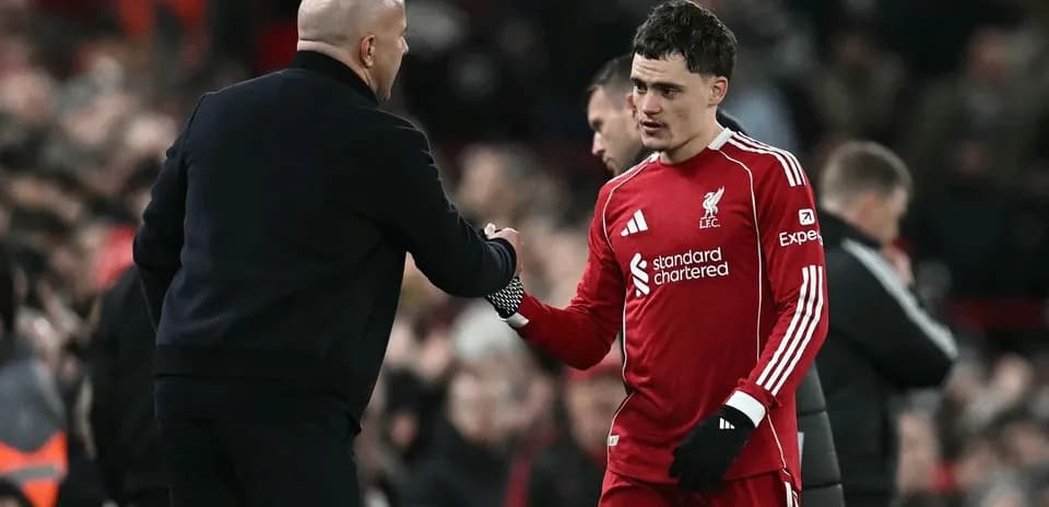 Goalkeeper shaking hands with coach after match