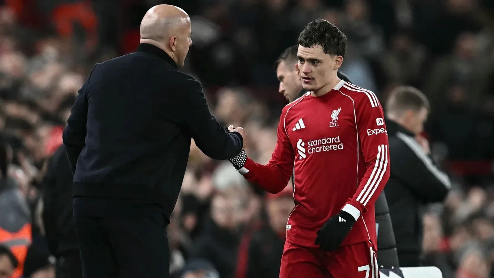 Goalkeeper shaking hands with coach after match