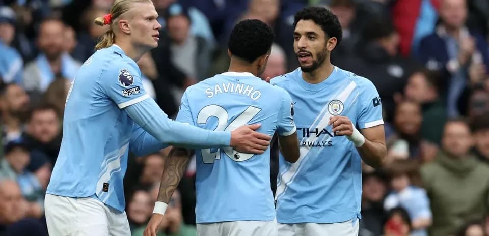 Manchester City players celebrating a goal together