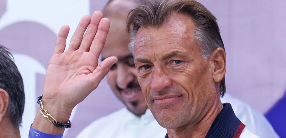 Coach waving during a press event