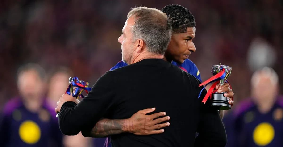 Player receiving trophy while embracing coach on field