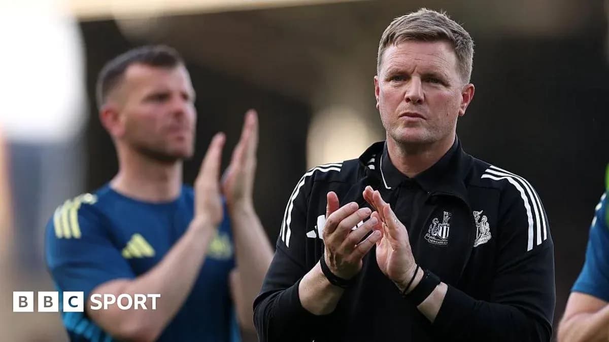 Coach clapping during match with players behind