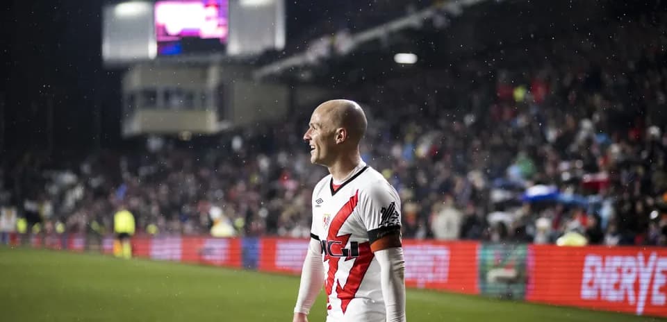Rayo Vallecano player celebrating in the rain