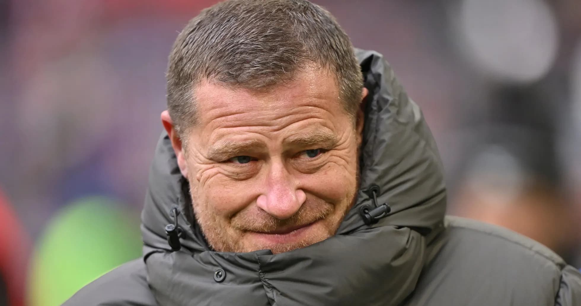 Coach wearing a jacket on the sidelines