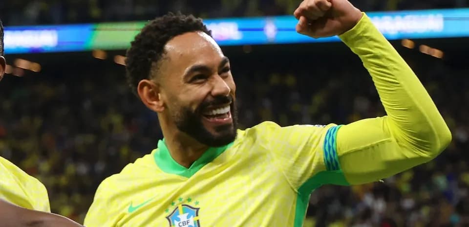 Player celebrating with raised fist in Brazil kit