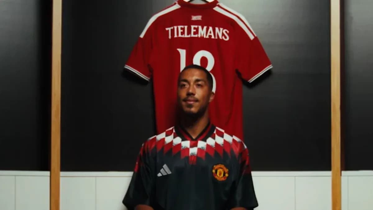 Player in Manchester United jersey with red shirt behind