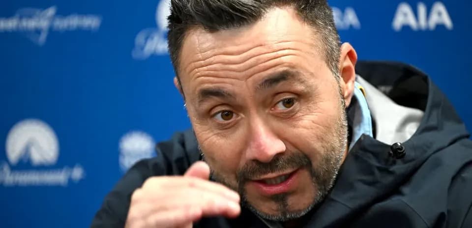 Manager speaking during press conference with hand gesture