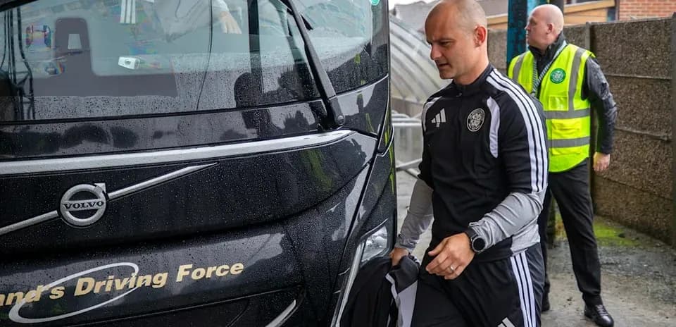 Team staff boarding bus in rainy weather