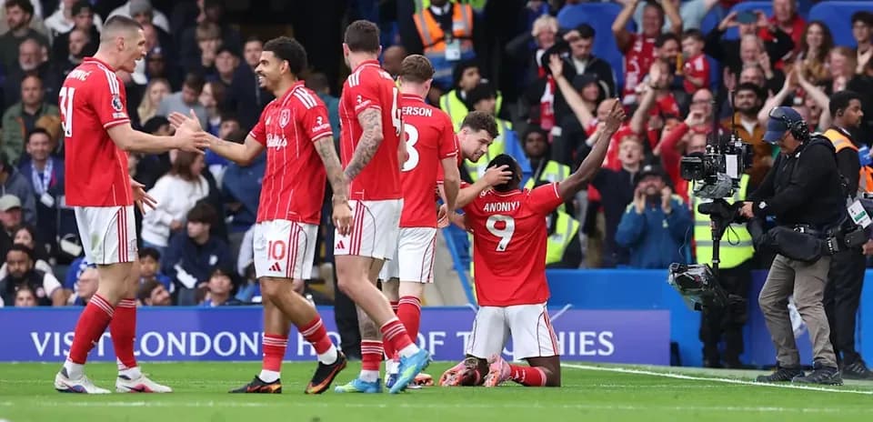 Players celebrating a goal on the pitch