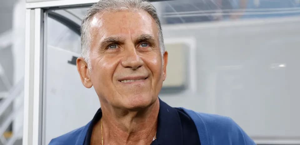 Coach smiling from the technical area during match