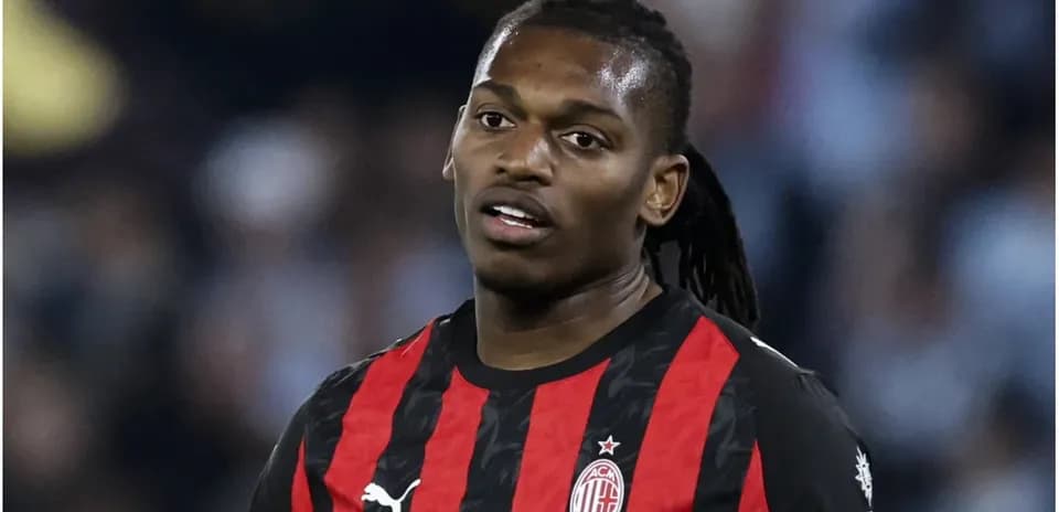 Player wearing AC Milan jersey on field