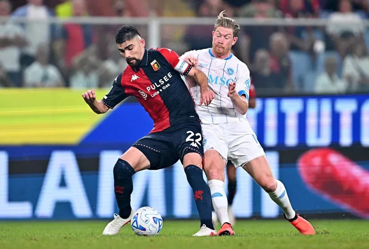 Genoa player tackling Napoli player during match