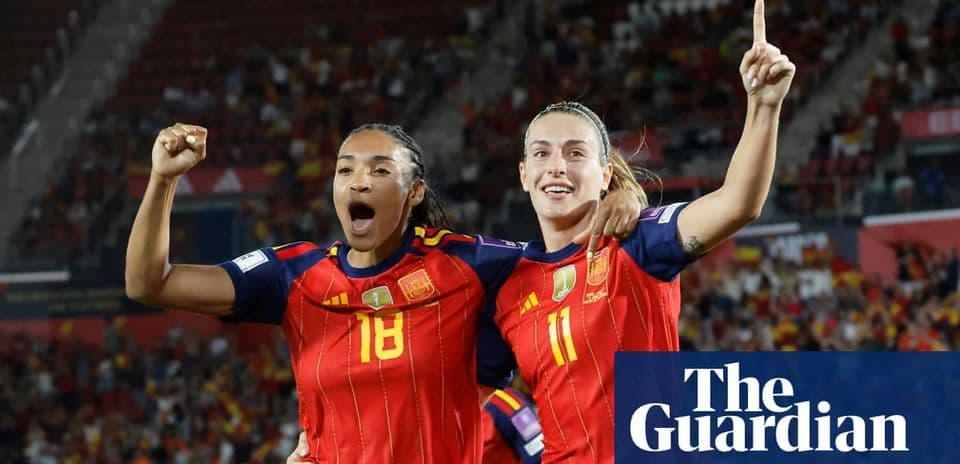 Two Spanish players celebrating a goal during match