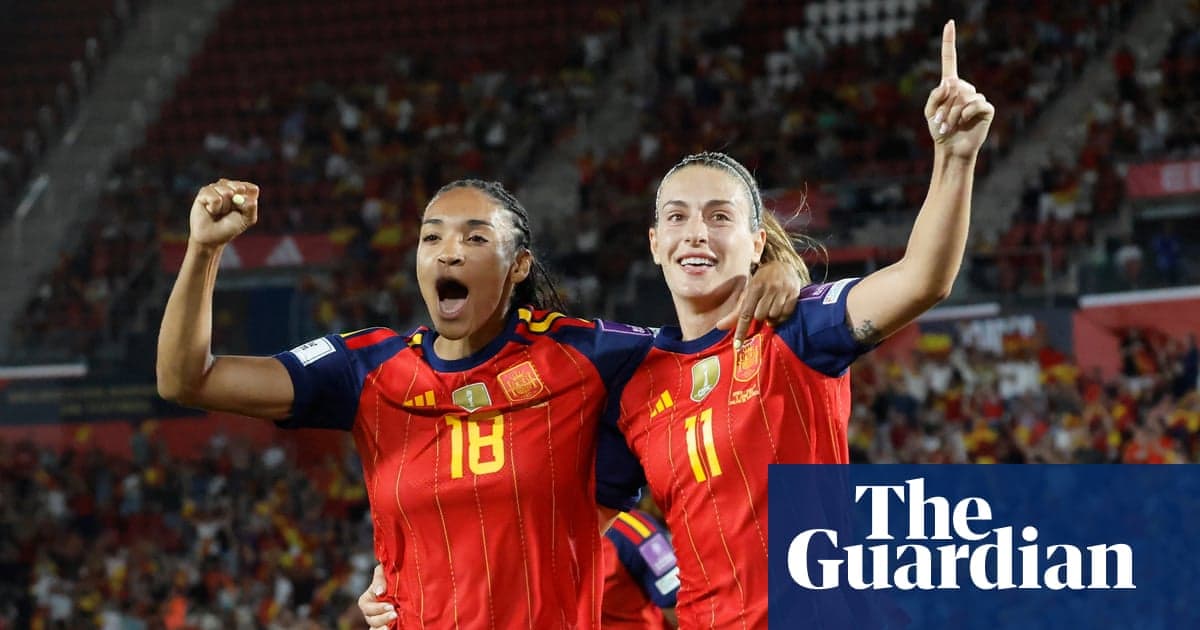 Two Spanish players celebrating a goal during match