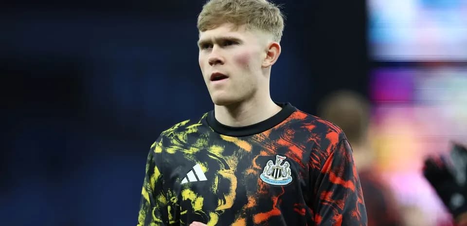 Player in Newcastle United goalkeeper jersey during warm-up