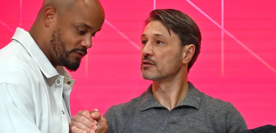 Two men shaking hands at press event