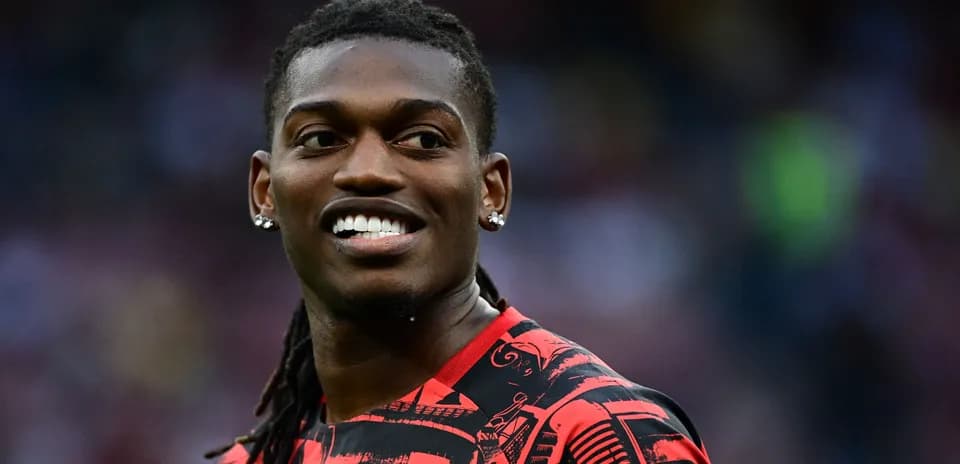 Player smiling during warm-up in red jersey