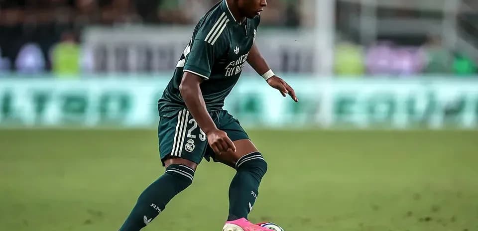 Player dribbling ball during match in green kit