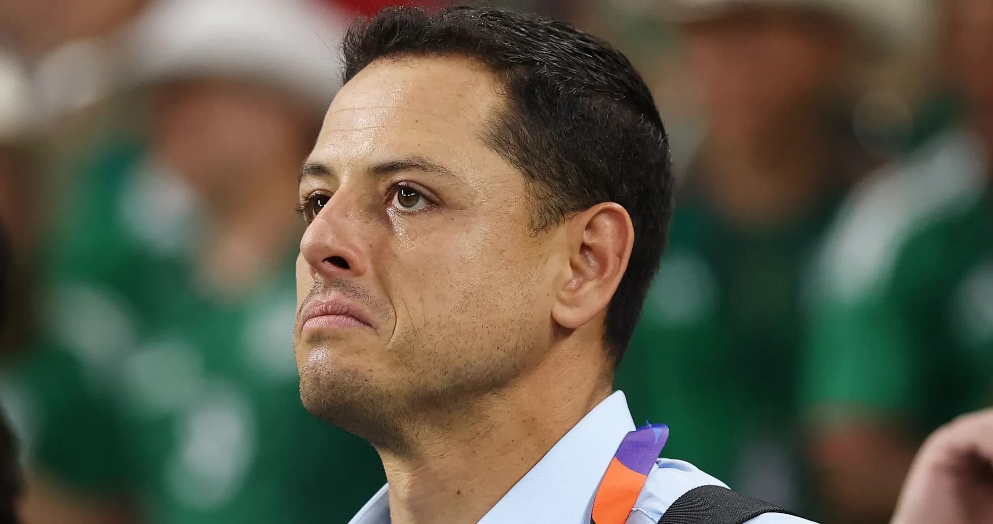 Man with tearful expression in crowd at event