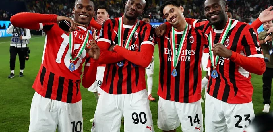 AC Milan players celebrating with medals after victory