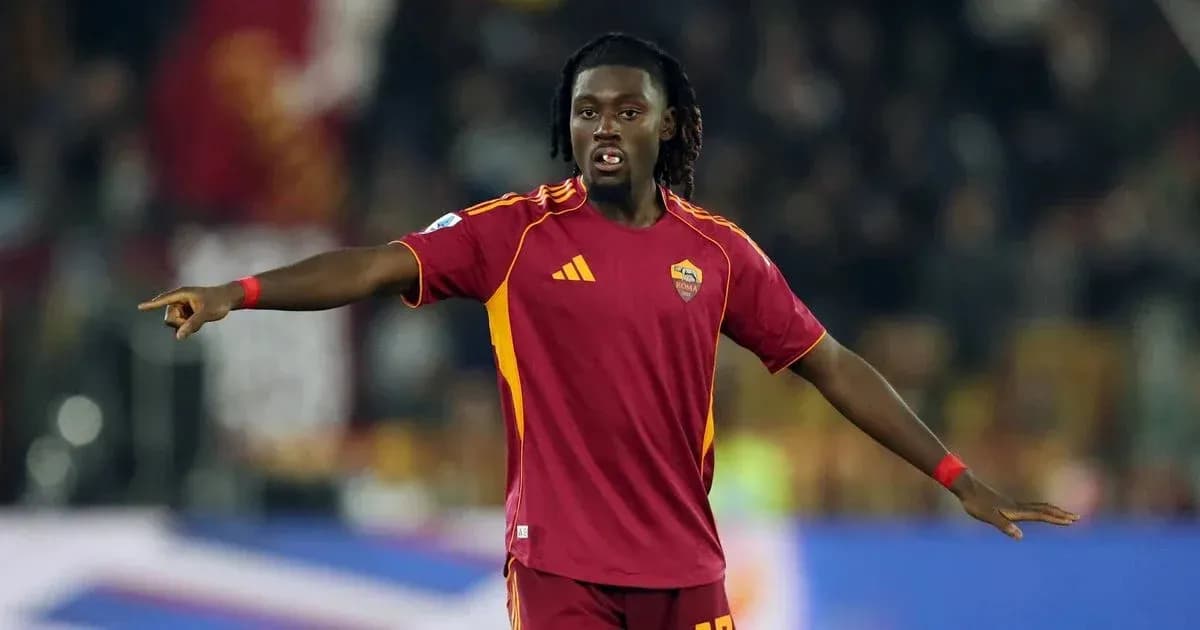 Player in AS Roma jersey directing teammates on field