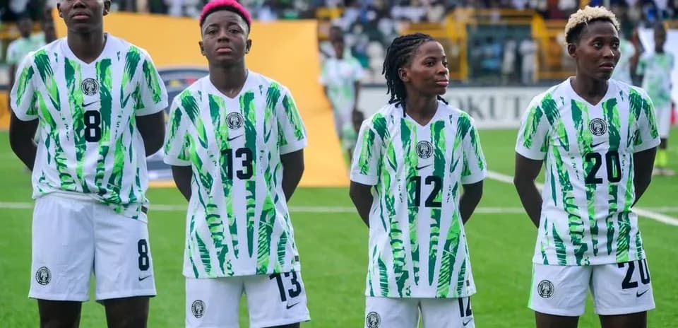 Four Nigerian players in team uniforms before match