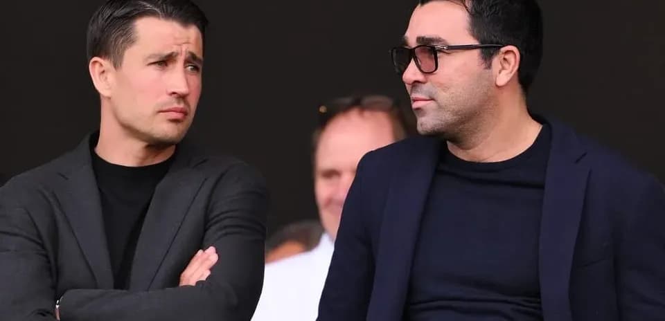 Two men discussing in a sports venue