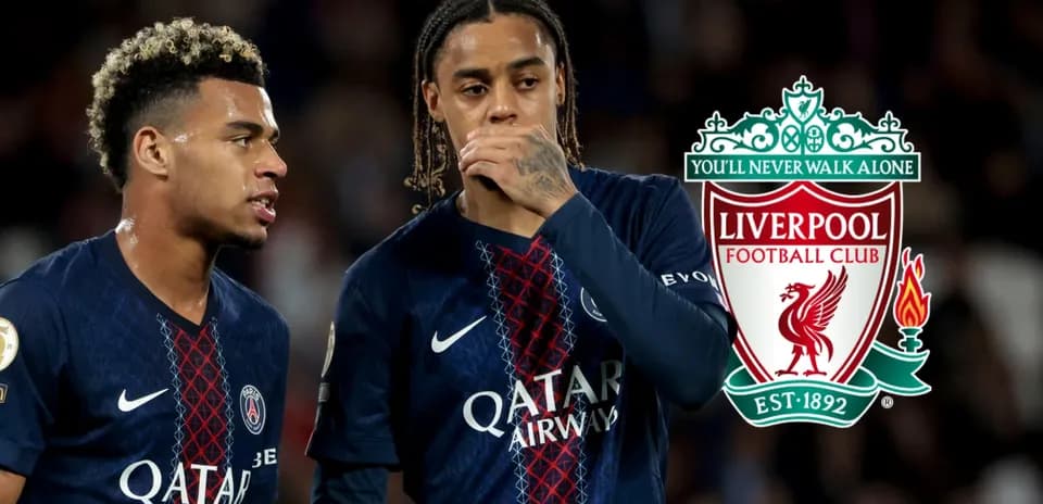Two players in PSG jerseys discussing during match