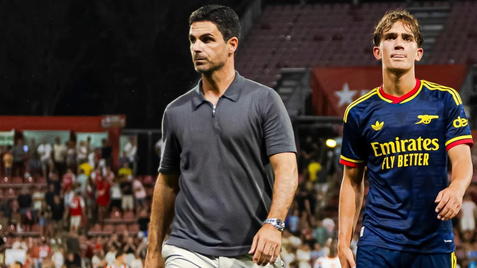 Coach and player walking off the field after match