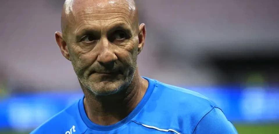 Coach in blue training kit on the field