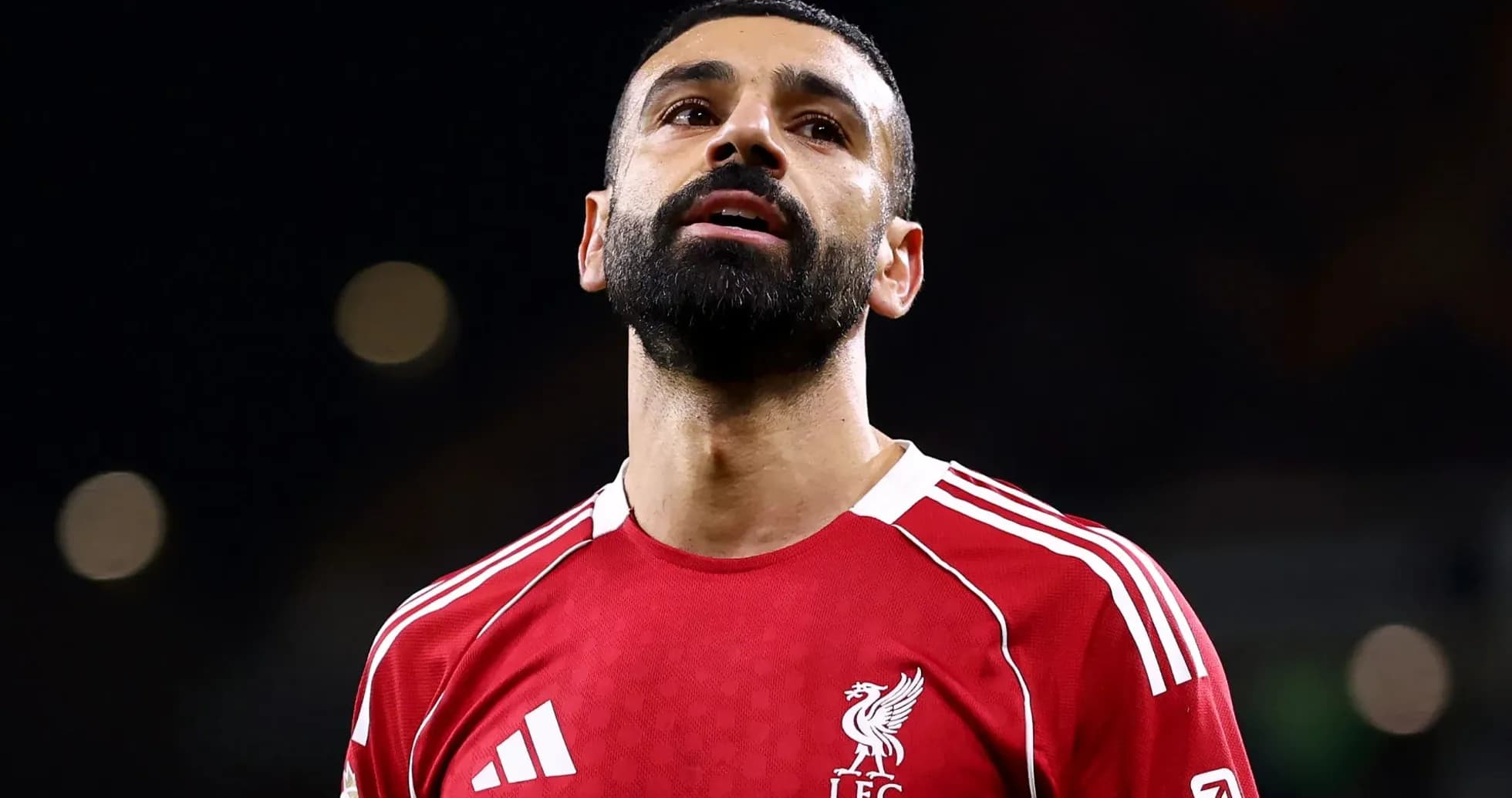 Player in red Liverpool jersey looking up