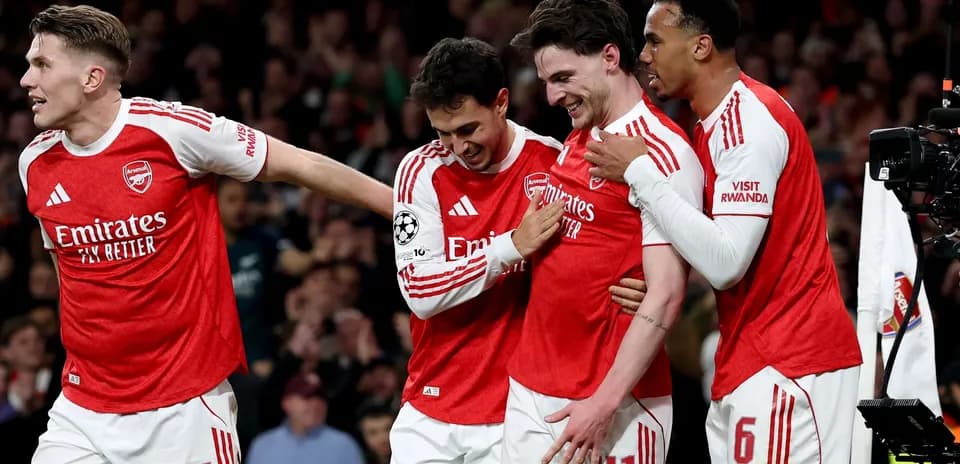 Arsenal players celebrating a goal in Champions League