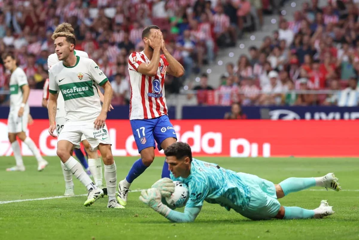 Elche player reacts as Atletico Madrid goalkeeper saves