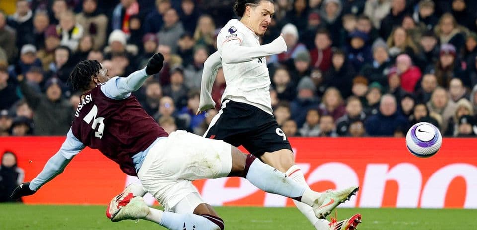 Aston Villa player tackling Liverpool forward