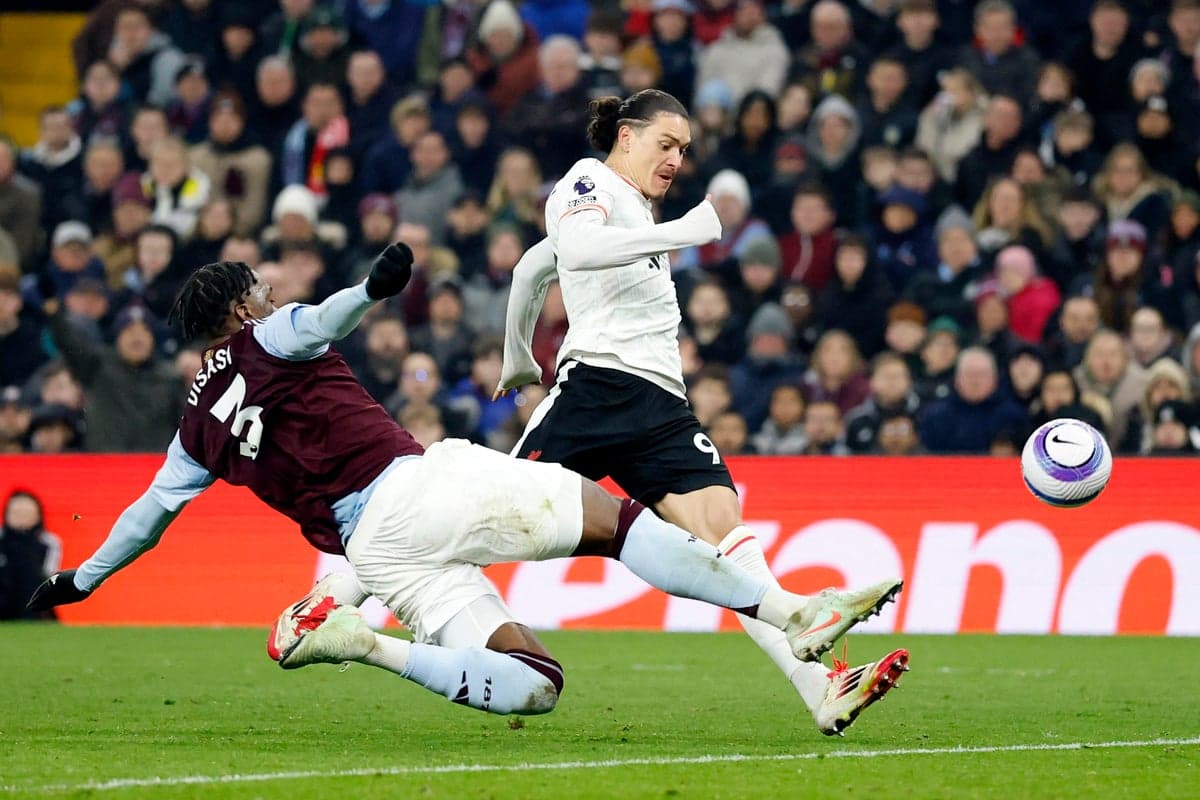 Aston Villa player tackling Liverpool forward