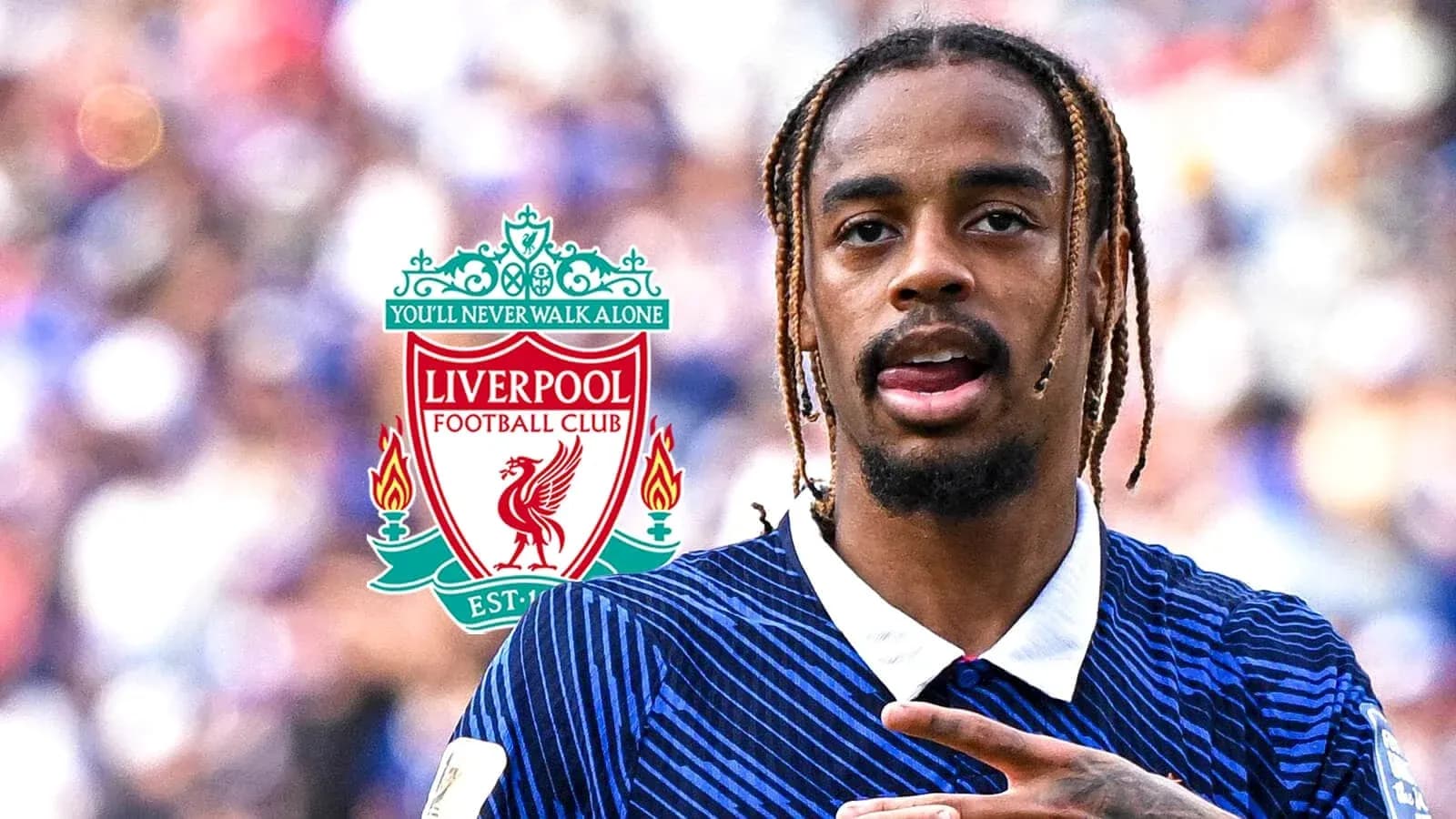 Player gesturing during match with Liverpool logo in background