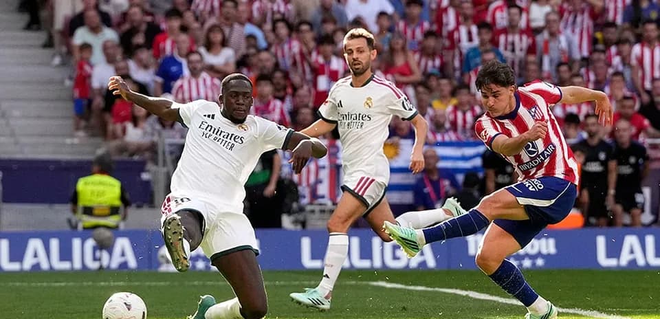Atletico player kicking ball against Real Madrid
