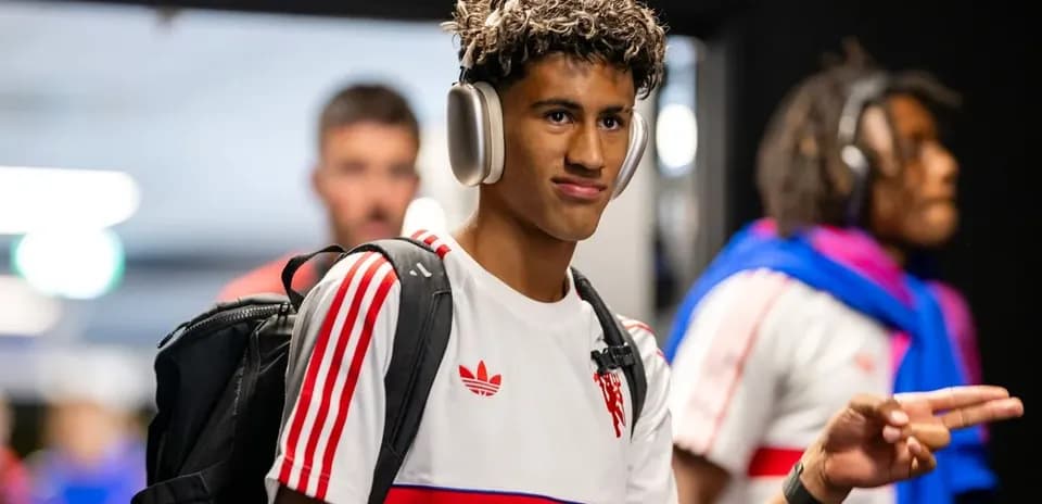 Player walking with headphones and backpack in hallway