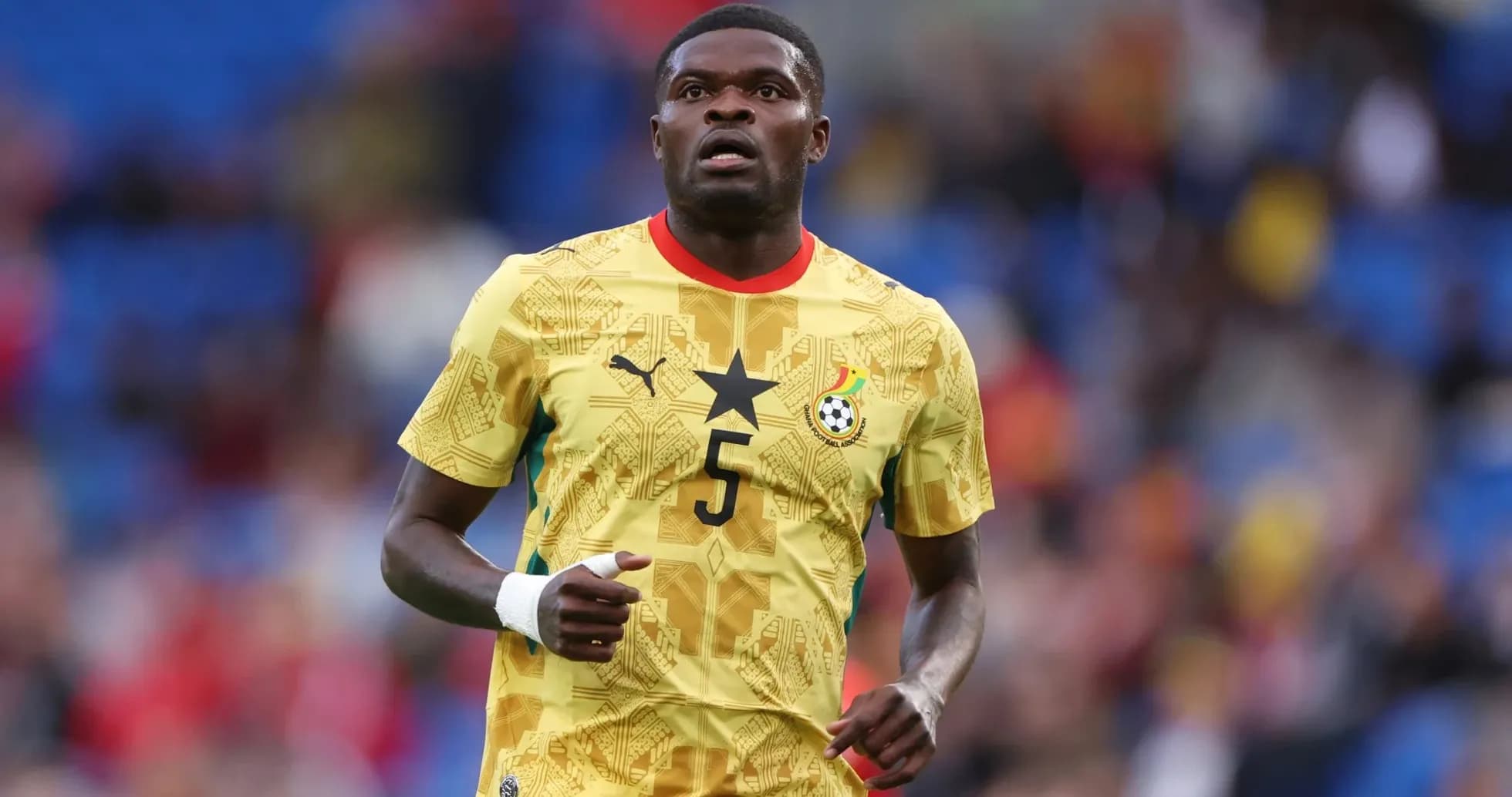 Ghana player wearing yellow jersey during match