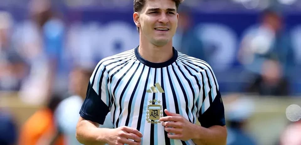Player in striped jersey holding trophy on field