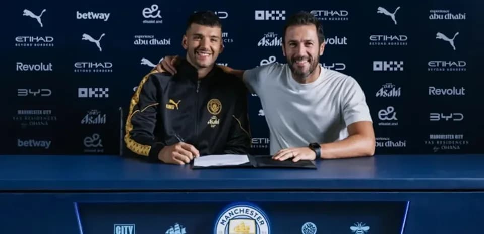 Player signing contract with manager at press table