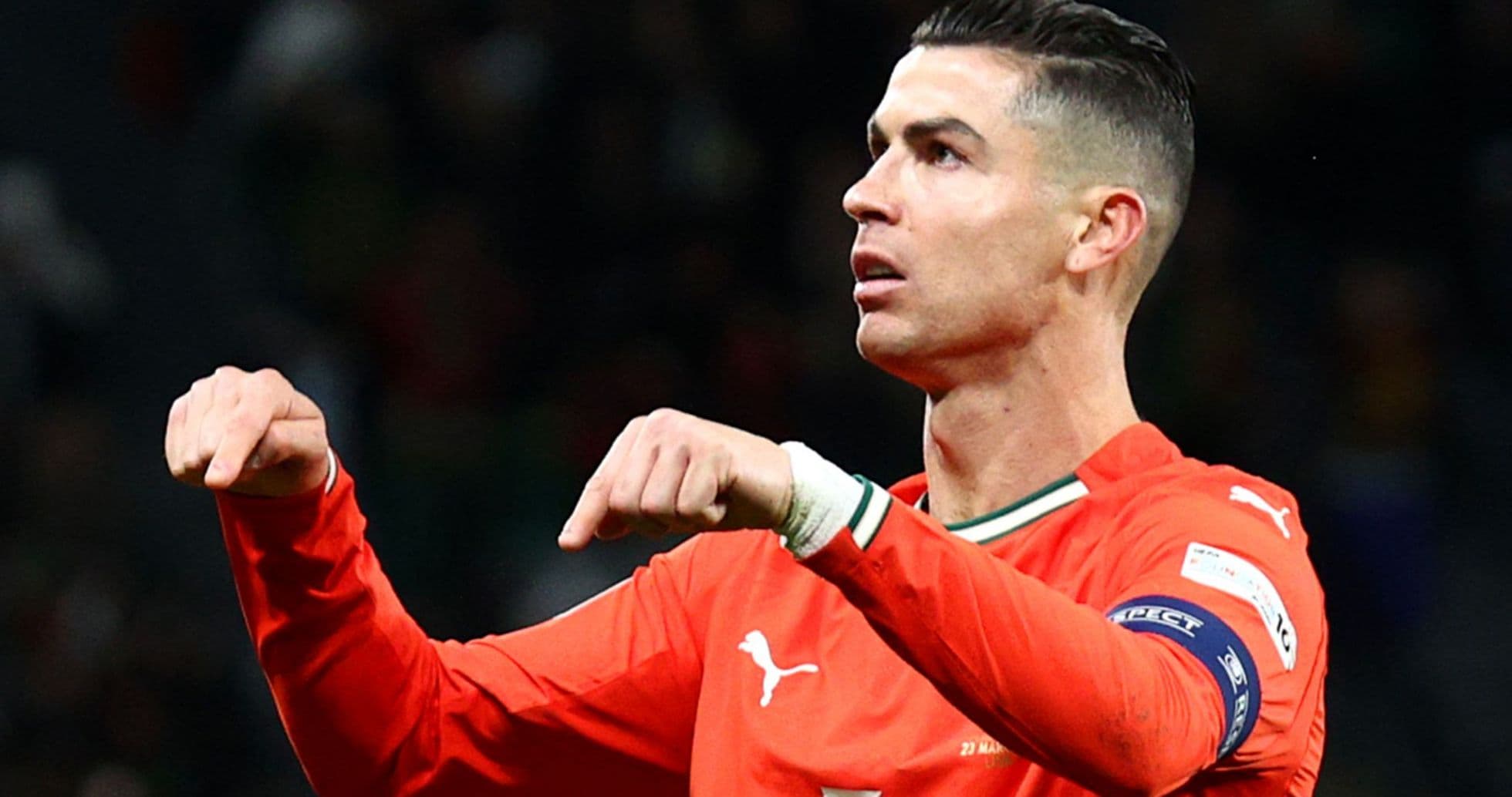 Player gesturing during a match in orange jersey
