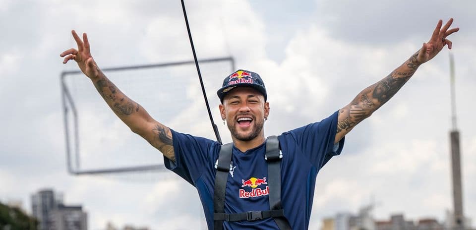 Neymar celebrating with arms raised outdoors