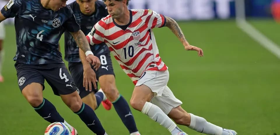 Player with ball evading tackle from opponent during match