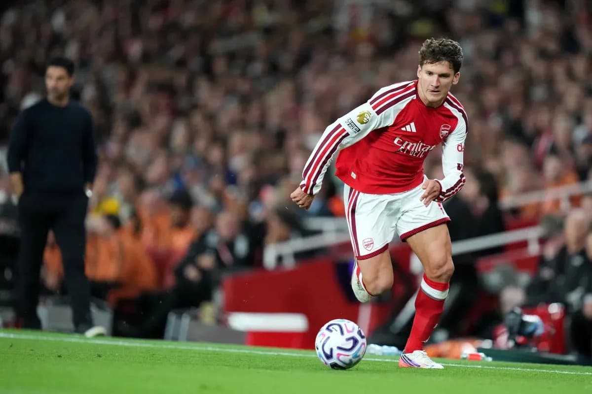 Arsenal player taking a throw-in during match