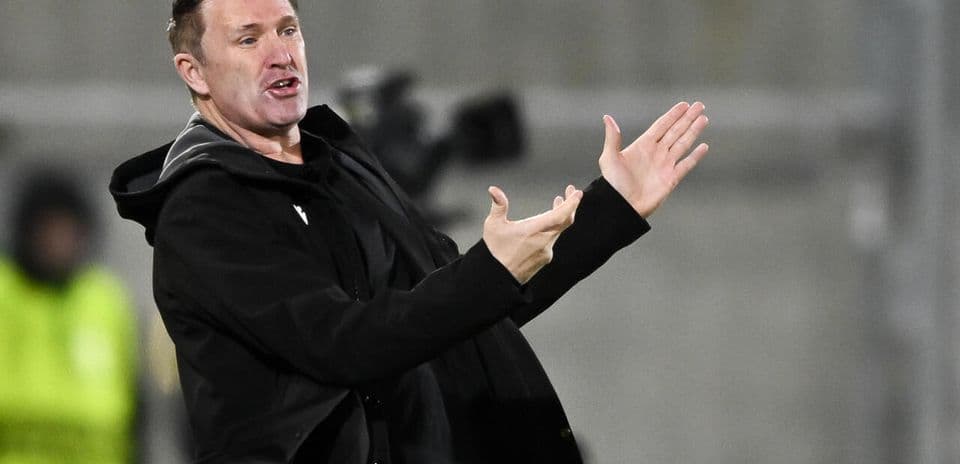 Coach gesturing during a match on the sidelines