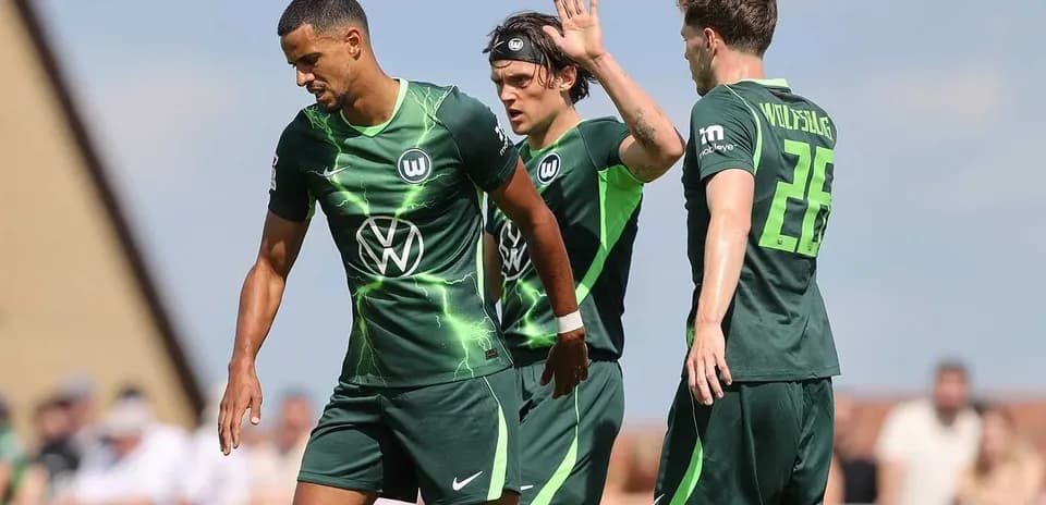 Wolfsburg players celebrating on the field during match